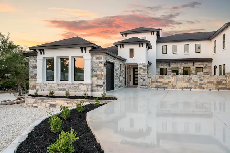 Modern home with stone accents at sunset