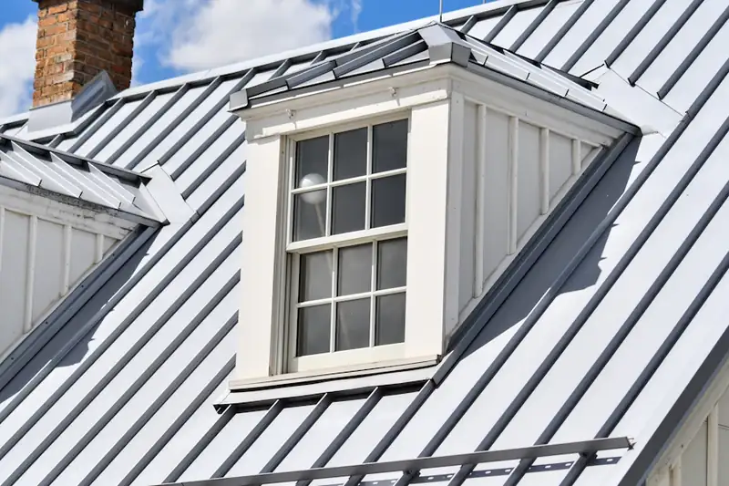 White dormer window on a standing-seam metal roof